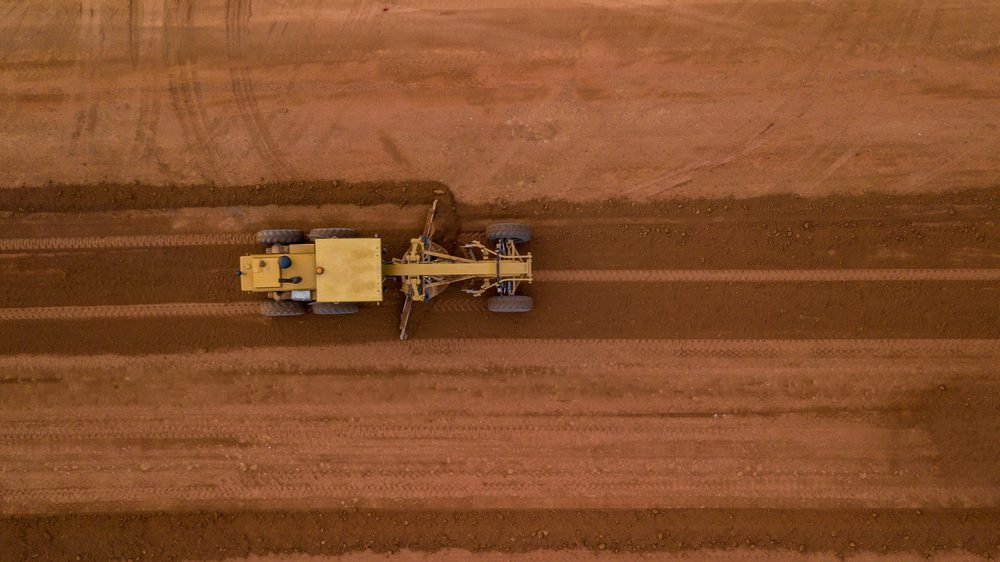 Caliche driveway installation at rural property in West Texas